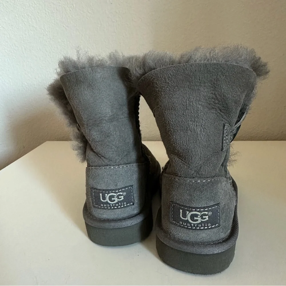 UGG Bailey Button II boots in grey suede with a single wood-button closure.